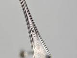 a spoon with a fork sticking out of it