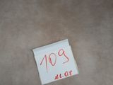 a piece of paper on the floor with a sticker on it