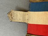 a small patch with a flag on it on a table