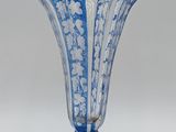 a blue and white vase sitting on a white surface