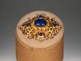 gold and lapis ring with blue stones in a wooden box