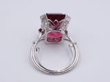 a close up of a ring with a pink stone in it