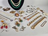 many different types of jewelry on display on a table