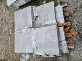 several pieces of concrete sitting on top of a pile of wood