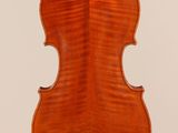 an old violin with a very long neck and a very long back