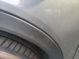 a close up of a car ' s front bumper with scratches on it