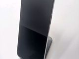 a cell phone that is on a stand on a table