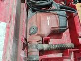 a red tool box with a hammer and other tools in it