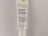 a close up of a tube of exfoliac cream on a white surface