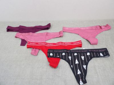 three pairs of underwear sitting on top of a bed next to each other