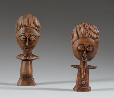 a pair of carved wooden figures of a woman and a man