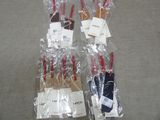 several pairs of scissors are wrapped in plastic bags on a table