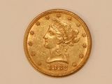 a close up of a gold coin on a white surface