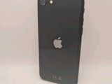 an apple iphone sitting on top of a table next to a white wall