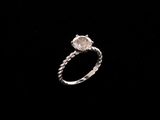 a close up of a diamond ring on a black background