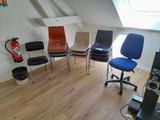 five chairs in a row in a room with a skylight