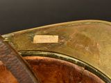 a close up of a horse ' s saddle with a tag on it