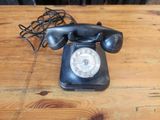 a black telephone sitting on a wooden table