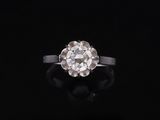an old cut diamond ring on a black background