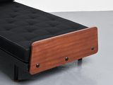 an image of a black couch with a wooden frame