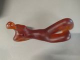a red glass figurine sitting on a white surface