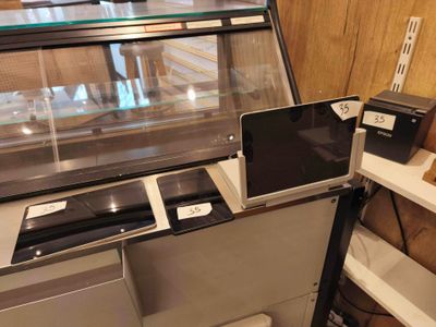 a display case with laptops and other electronic devices on it