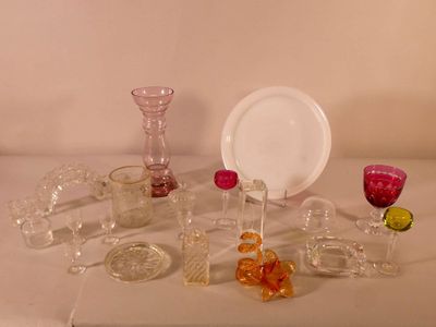 a table with a plate, cups, glasses, and a plate on it