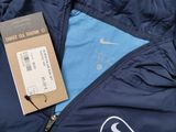 the jacket is blue and has a white logo on it