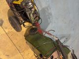 a man riding a bike with a cart full of items