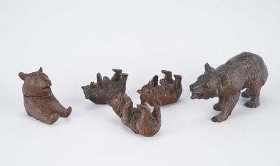 four wooden animals that are sitting in the snow