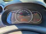 a close up of a car dashboard with a speedometer and a steering wheel