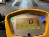 a yellow motorcycle with a digital display on the back of it