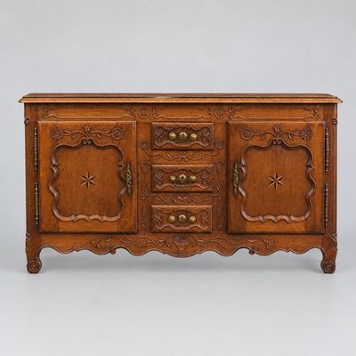 an antique carved oak sideboard with four drawers and two doors