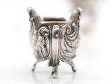 a silver ring with a green stone in the middle of it