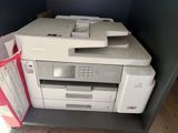 a printer that is sitting on top of a shelf