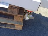 a white refrigerator sitting on top of a wooden pallet
