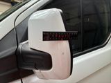 a white van with a red sticker on the side mirror