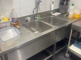 a kitchen with a stainless steel sink and a stainless steel counter top
