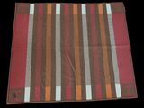 a close up of a red and brown striped cloth on a black background