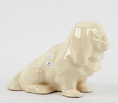 a figurine of a dog sitting on a white surface
