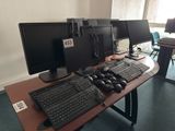 two computer monitors and a keyboard on a desk
