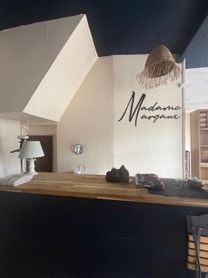 a picture of a kitchen with a bar in the middle of it