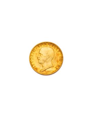 gros plan d'une pièce d'or sur une surface blanche