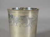 a silver cup that has a design on it