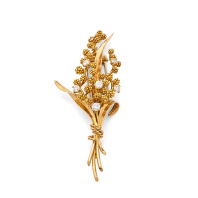 a close up of a brooch with a bunch of flowers on it