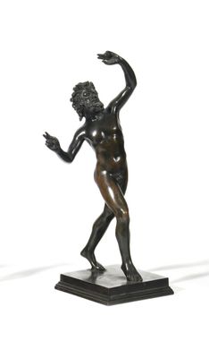 bronze statue of a man holding a tennis racquet on a marble base