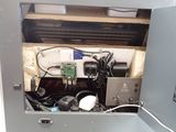 a metal cabinet with electronic equipment inside of it