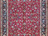 a red and blue rug with a floral design