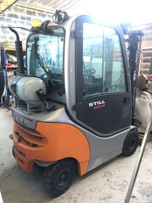 a forklift truck that is parked in a garage