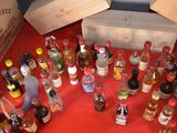 many bottles of alcohol sitting on a red table